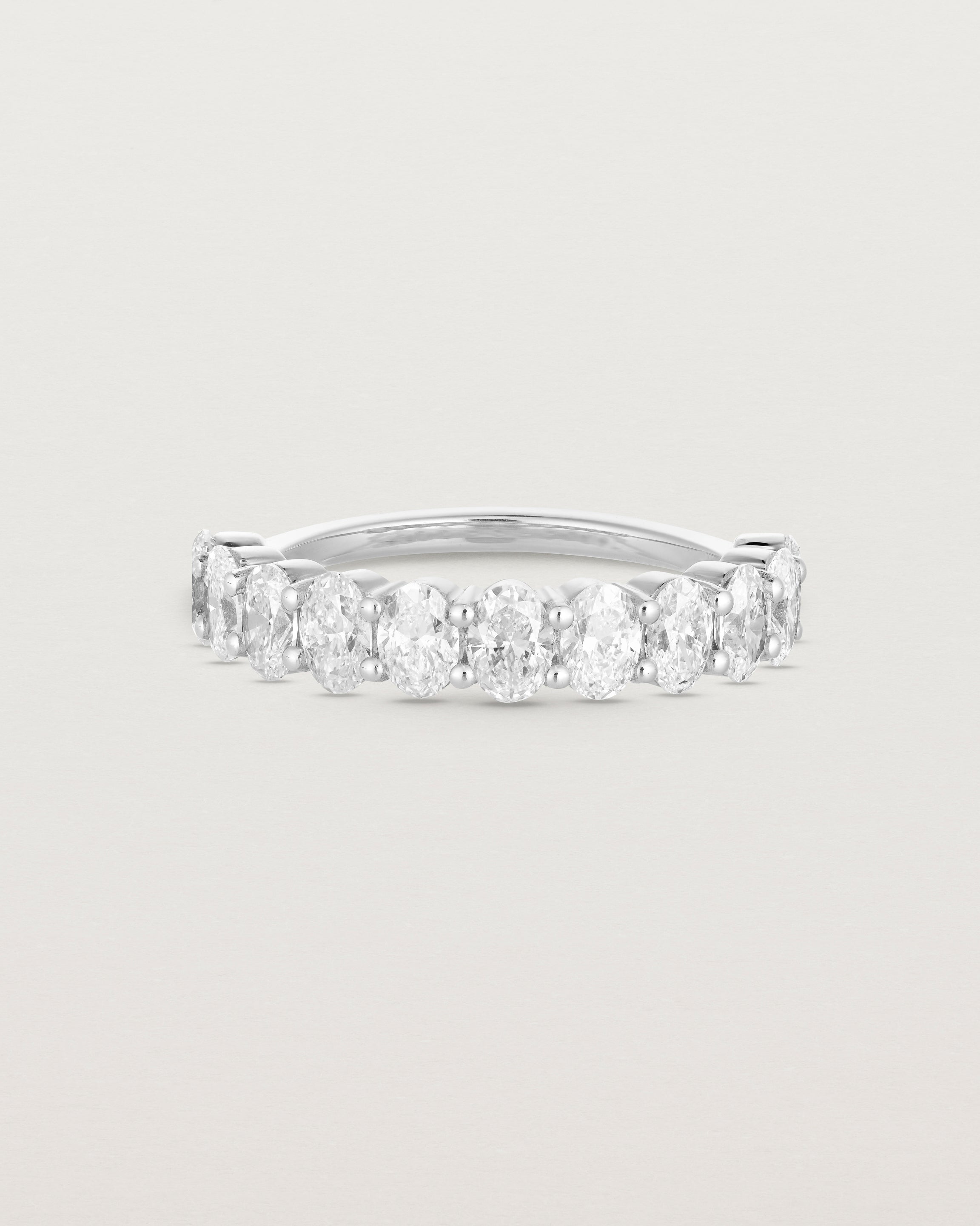 front on deep etched image of a white gold wrap engagement ring with 11 white diamonds.