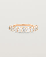 Front on deep etched image of a rose gold wrap engagement ring with 11 white diamonds.