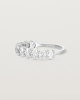  side on deep etched image of a white gold wrap engagement ring with 11 white diamonds.