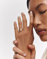 image of a woman wearing a yellow gold solitaire engagement ring