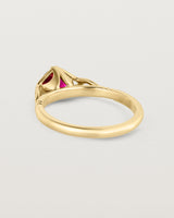 Back facing deep etched image of a yellow gold vintage inspired ring with a cushion cut ruby.