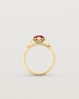 Standing deep etched image of a yellow gold vintage inspired ring with a cushion cut ruby.