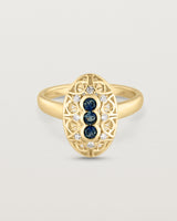 Front facing deep etched image of a yellow gold vintage inspired shield ring with three Australian sapphires and surrounded by eight old cut white diamonds.