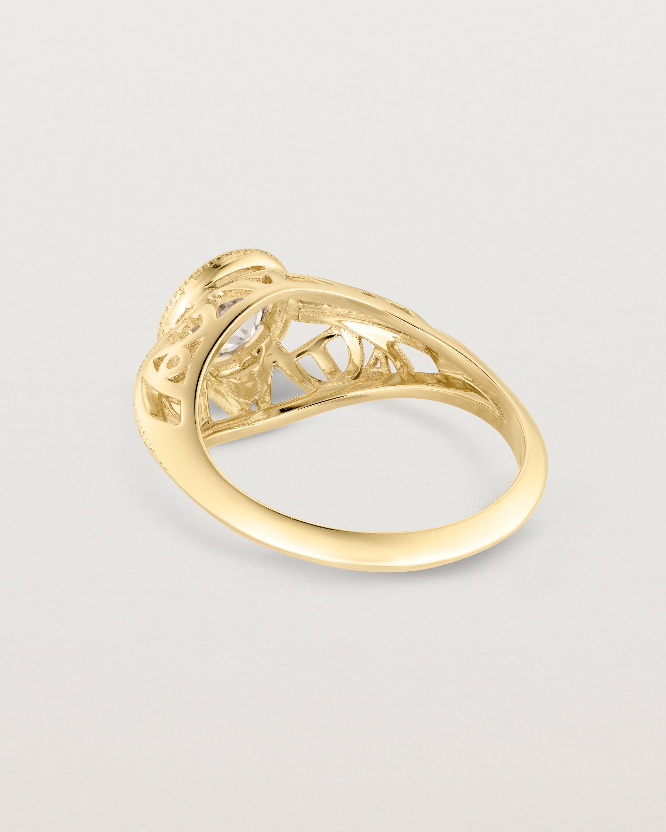 Back facing deep etched image of a yellow gold vintage inspired ring with old mine cut diamond, framed by an intricate filagree inspired gallery.