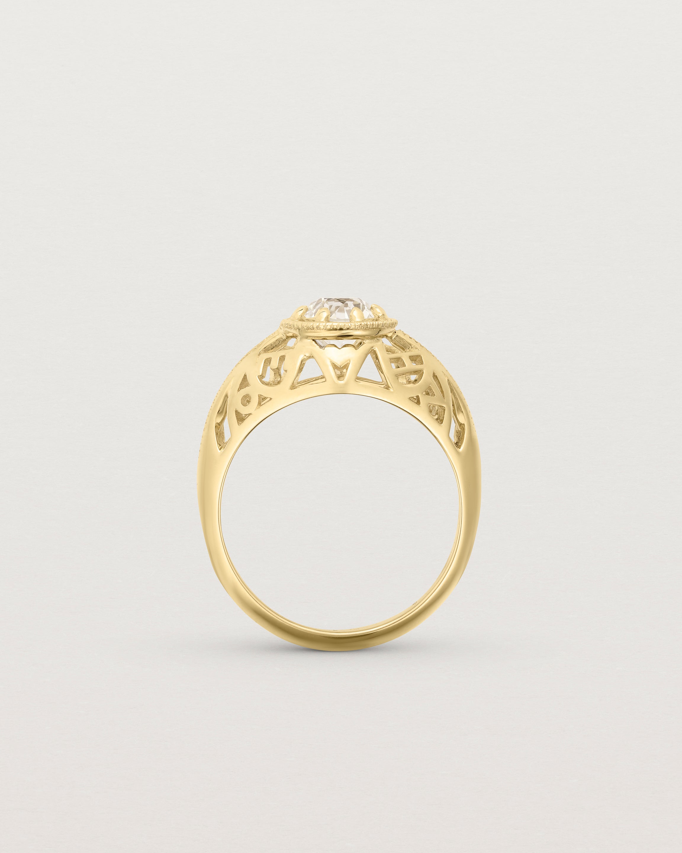 Standing deep etched image of a yellow gold vintage inspired ring with old mine cut diamond, framed by an intricate filagree inspired gallery.