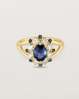 Front facing deep etched image of a yellow gold vintage inspired ring with an oval Ceylon Sapphire and a tiered halo of Old Cut Diamonds and Australian Sapphires.