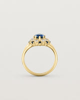 Standing deep etched image of a yellow gold vintage inspired ring with an oval Ceylon Sapphire and a tiered halo of Old Cut Diamonds and Australian Sapphires.