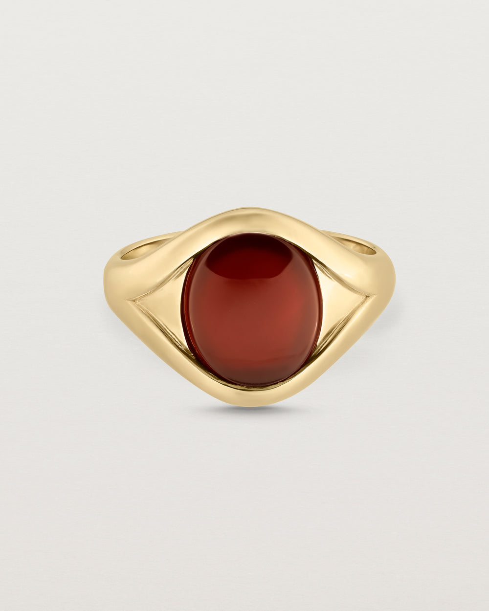 Front facing deep etched image of a yellow gold signet ring with carnelian.