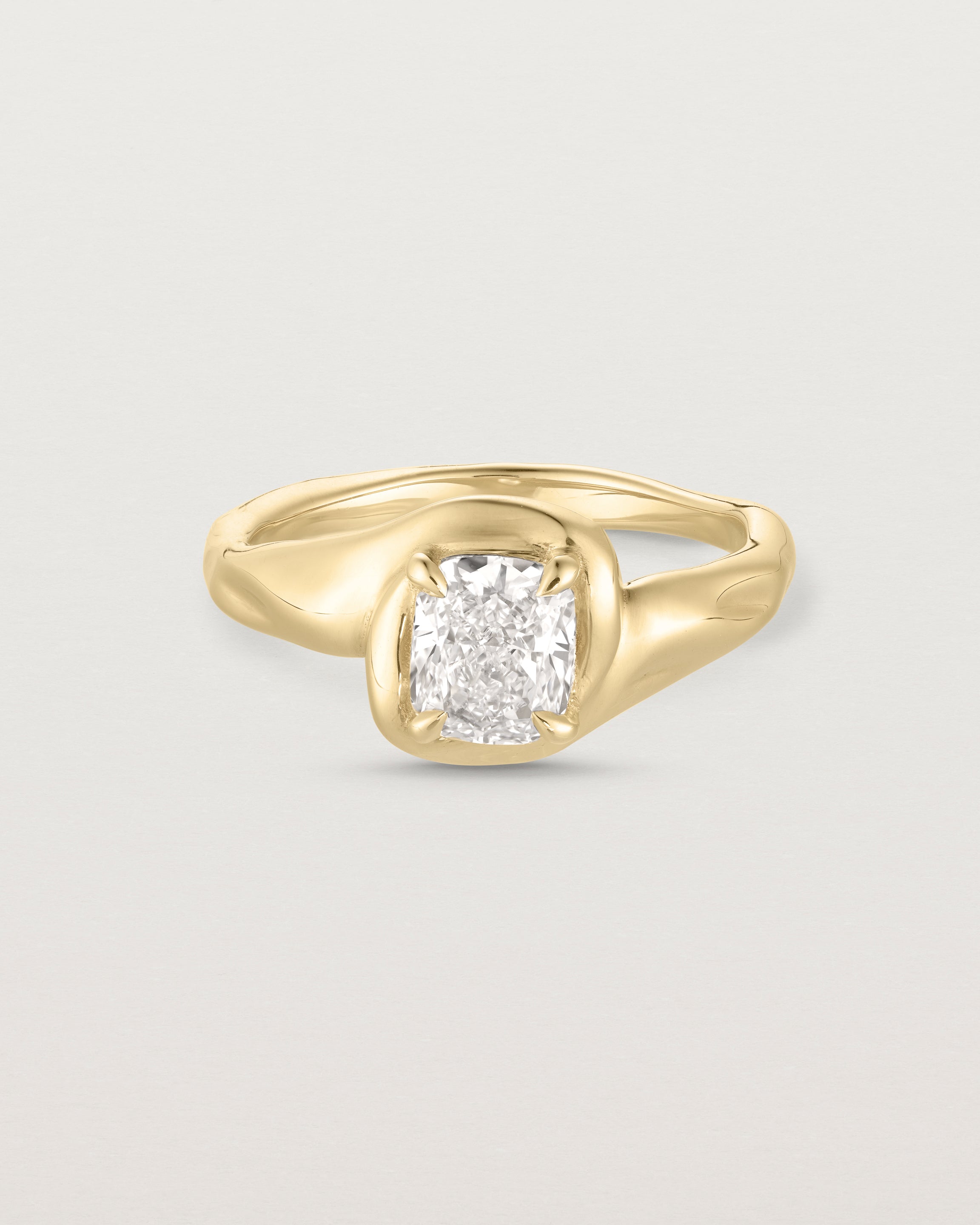 Front facing deep etched image of a yellow gold solitaire engagement ring