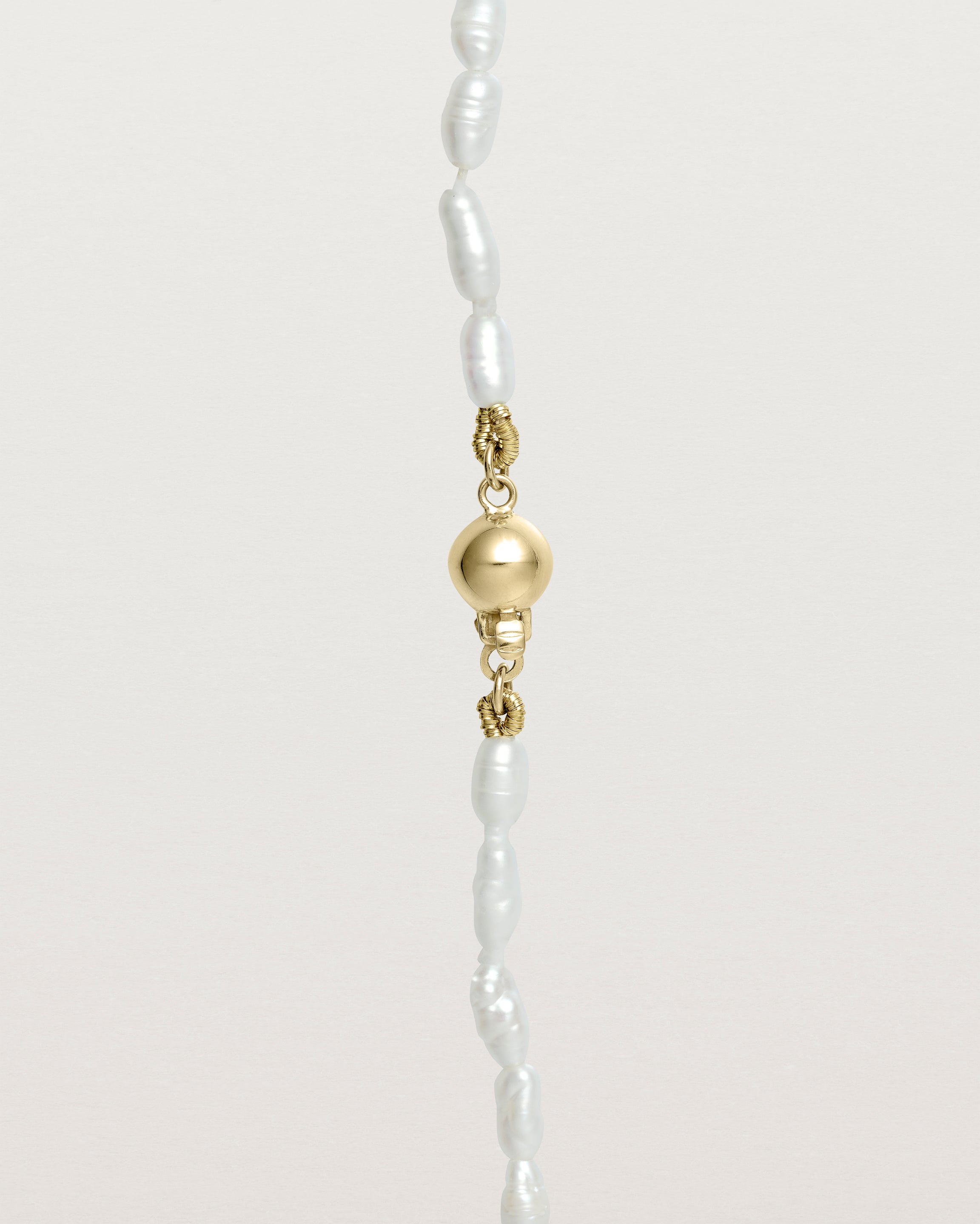 Deep etched image of the Sashi Pearl Necklace clasp detail in Yellow Gold