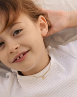 image of the Petits Eily necklace with diamond in yellow gold on a child model