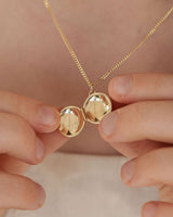 image of the starburst locket in rose gold being worn by a child model.