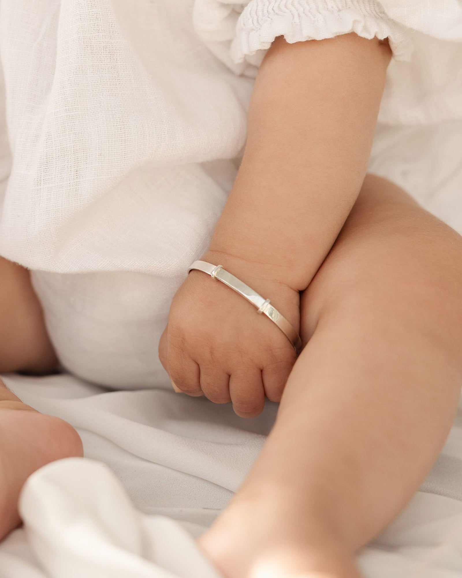 photo of a baby wearing the toujours bangle in sterling silver