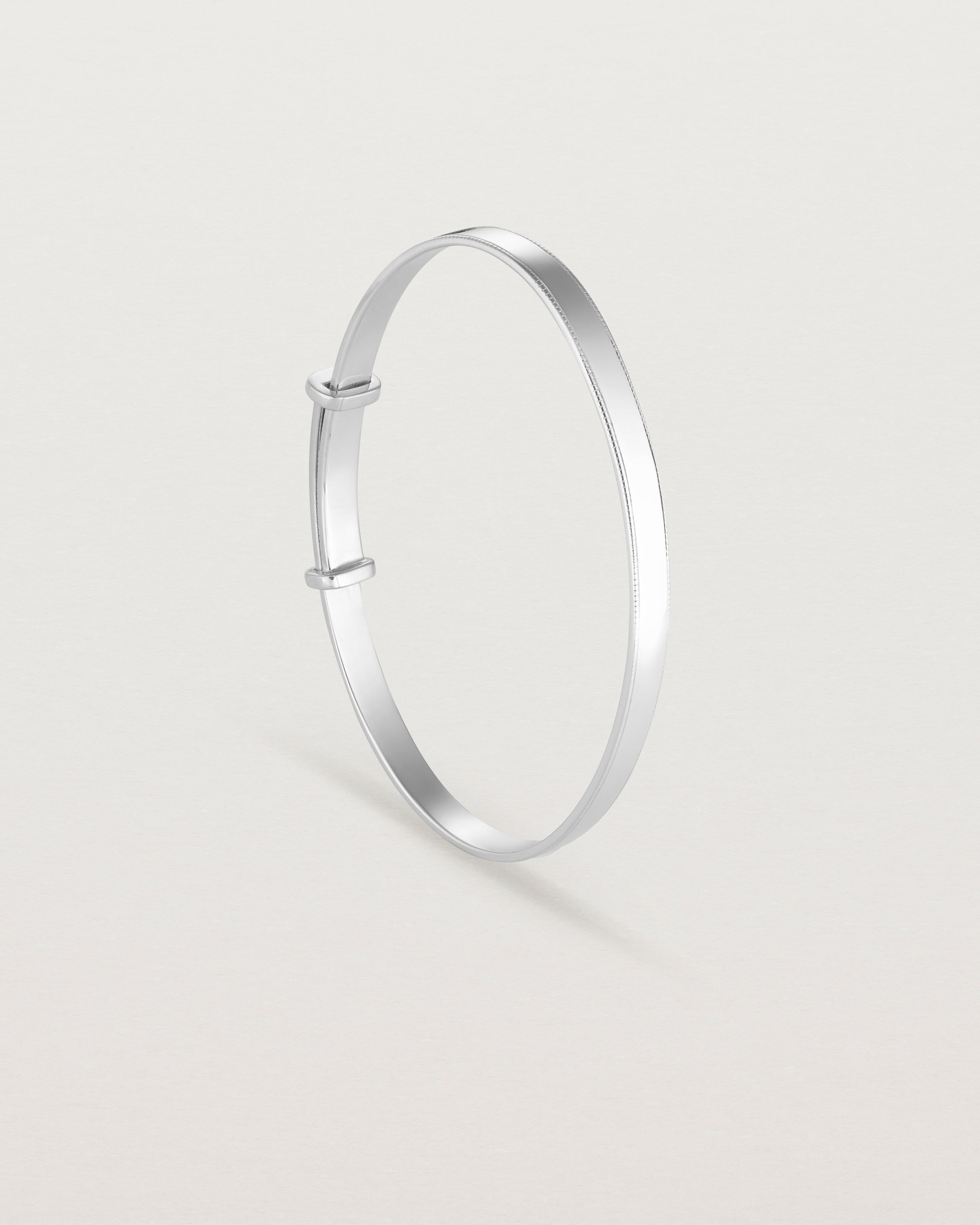 standing image of the Toujours Bangle with millgrain in Sterling Silver
