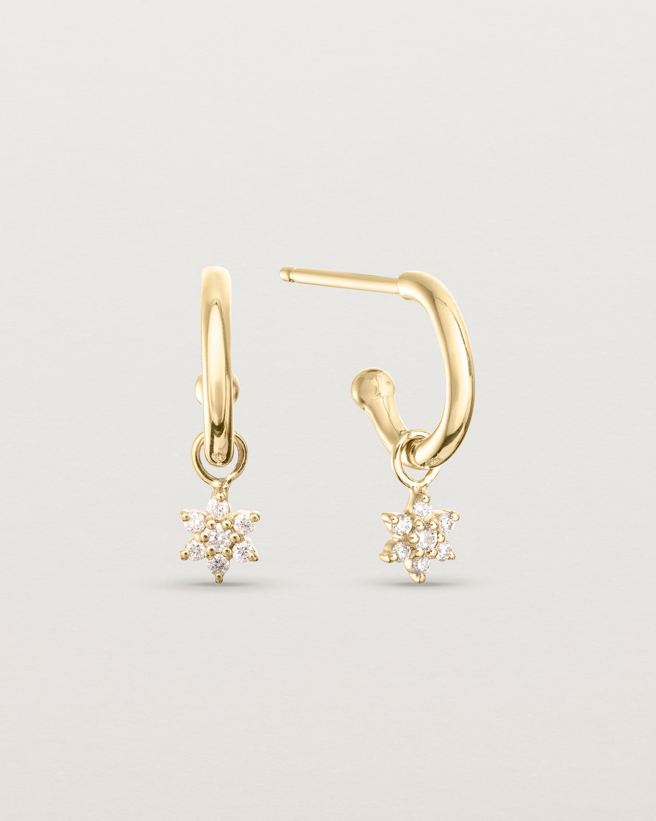 front of image of the pair of Starburst Petit Diamond Hoops on in yellow gold.