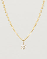 Close up image of the Starburst Diamond necklace in yellow gold