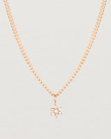 Close up image of the petits starburst diamond necklace in rose gold.