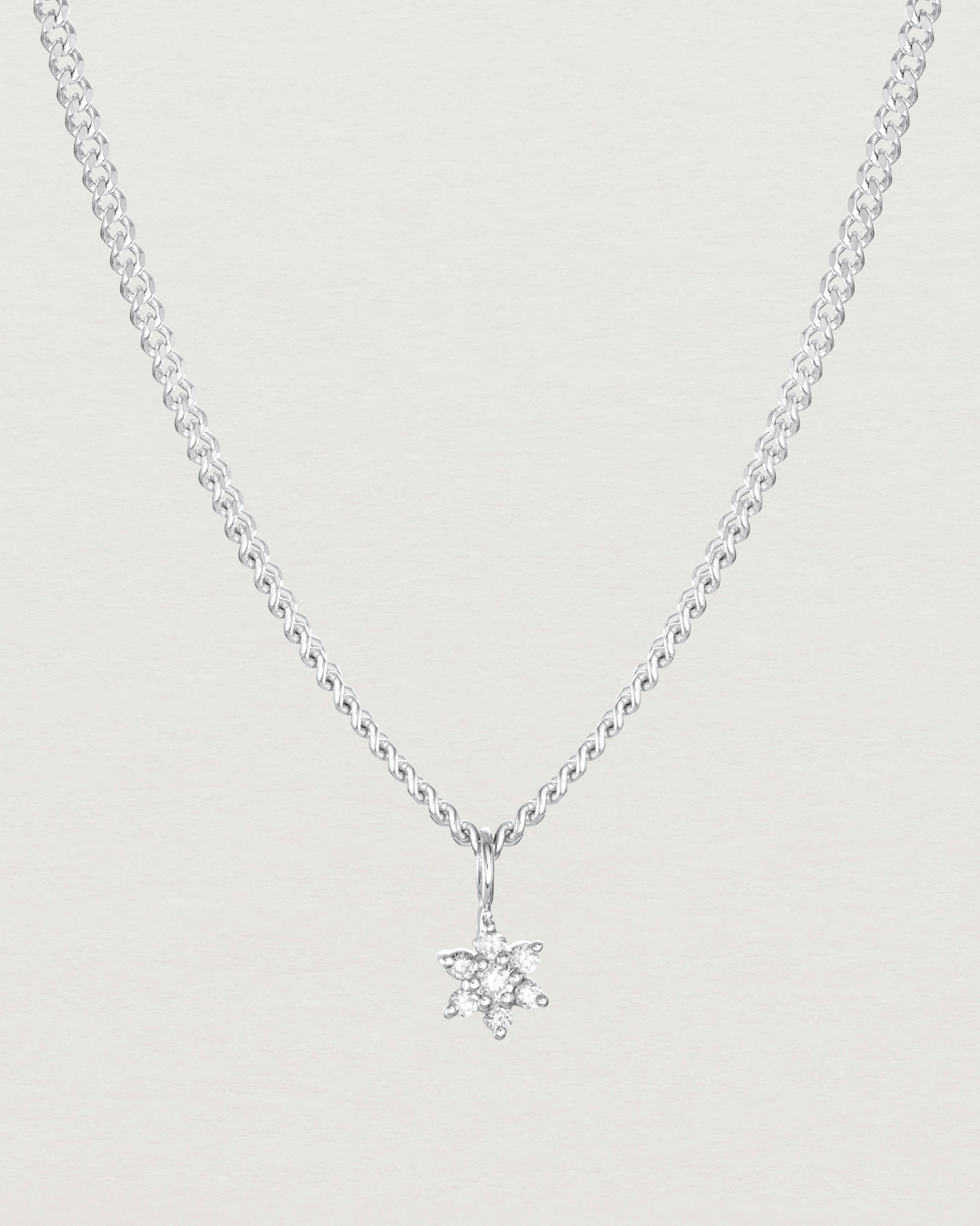 Close up image of the Petit Starburst Necklace in White Gold