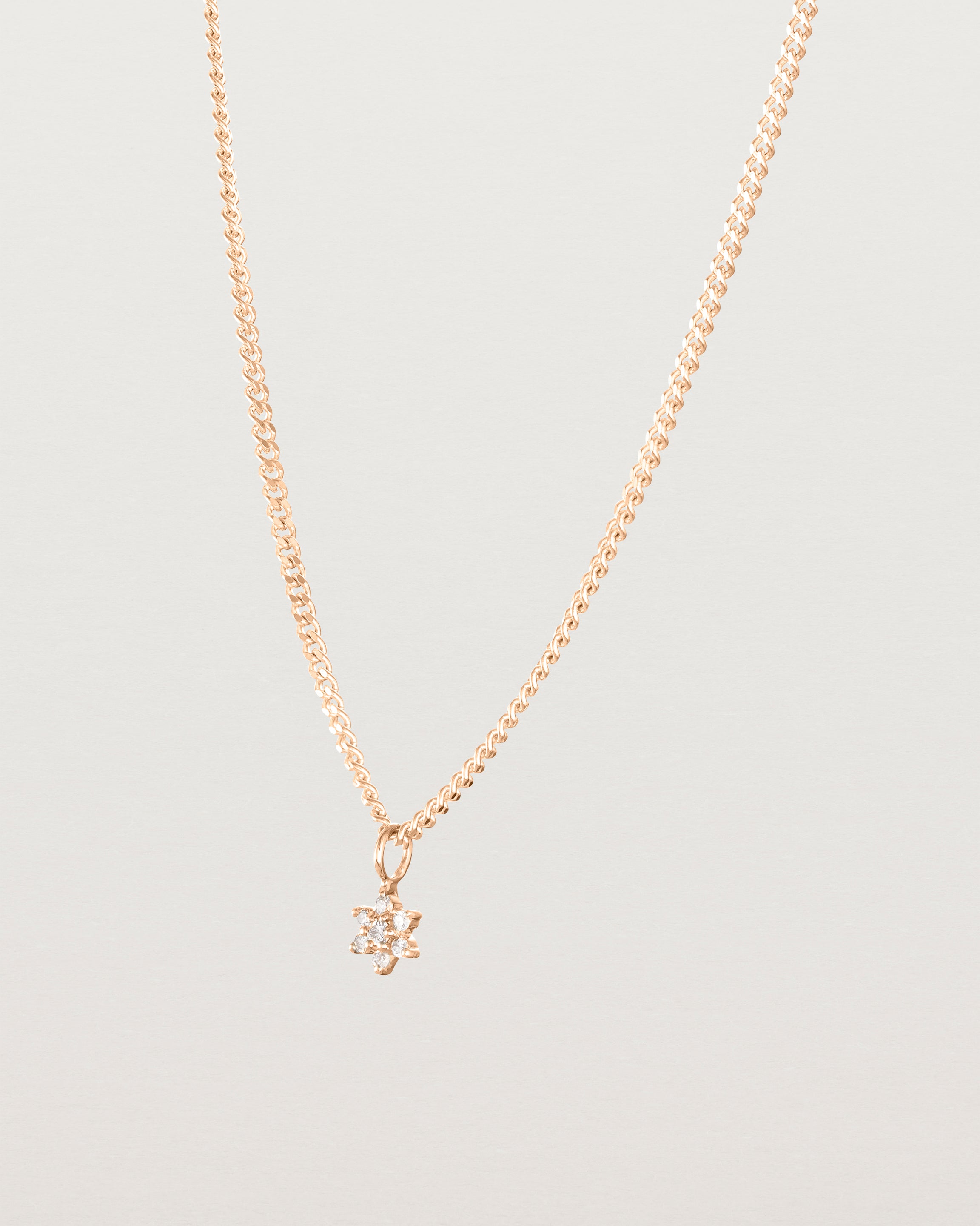 Side image of the petits starburst diamond necklace in rose gold.