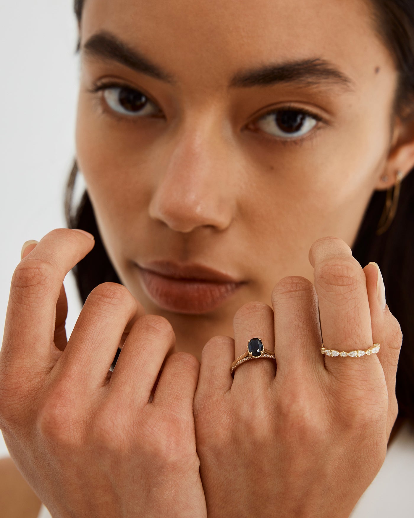 A woman wearing the Queenie Ring in Champagne Diamonds