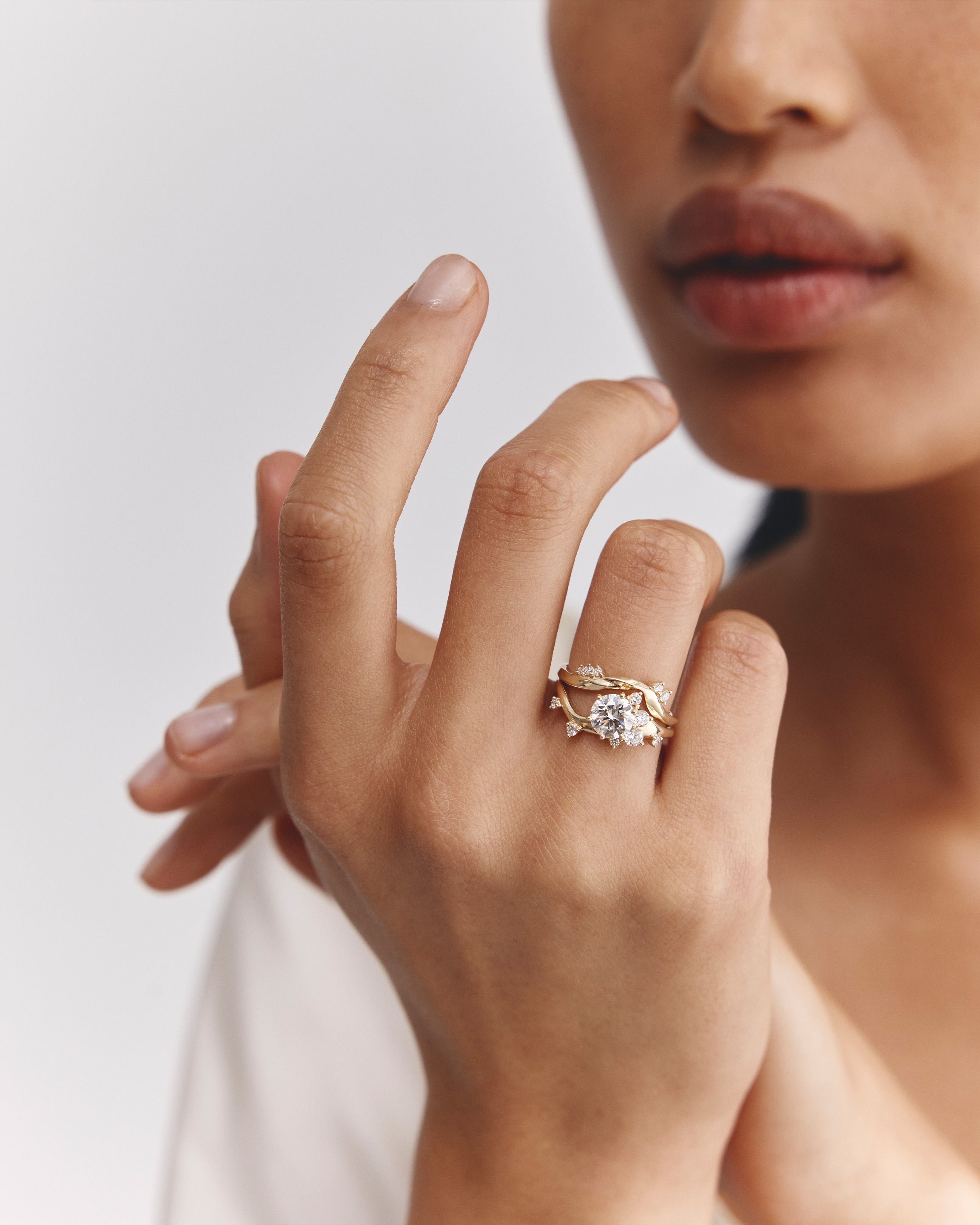 image of model wearing laboratory grown diamond engagement ring and a laboratory grown diamond wedding band 