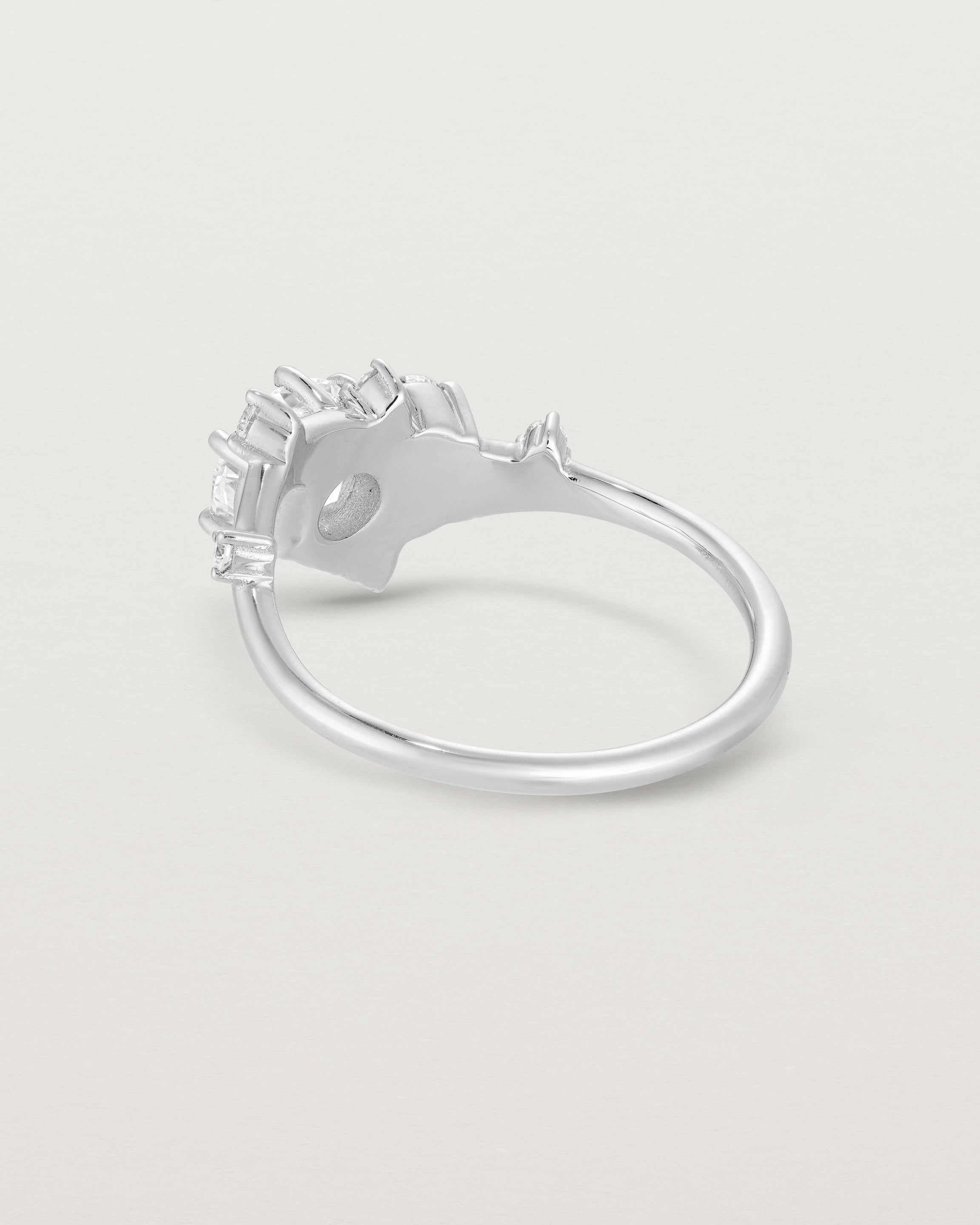 back facing deep etched image of a white gold  engagement ring with a cluster of laboratory grow diamonds