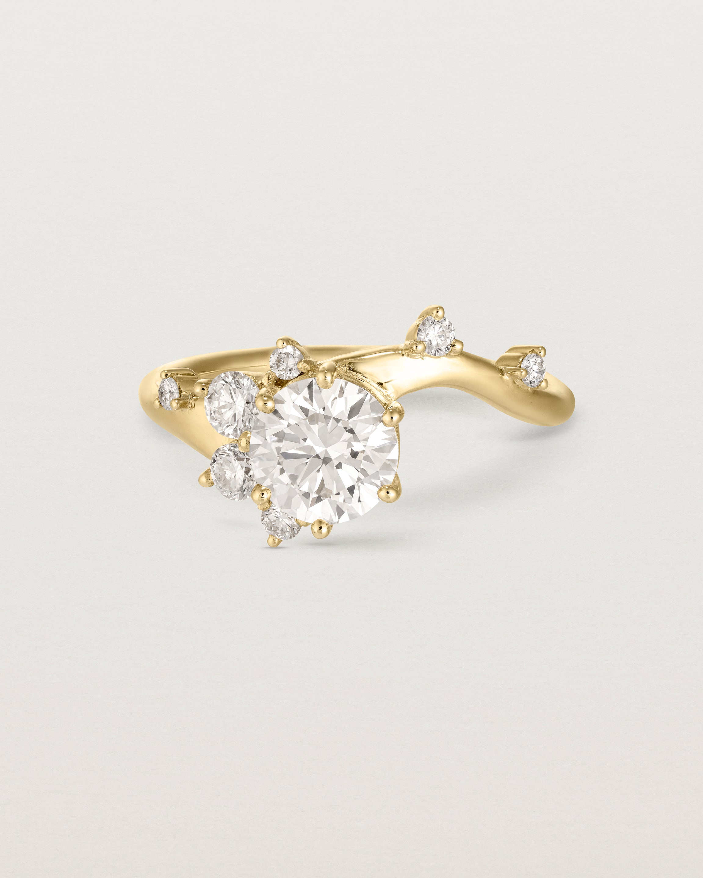 deep etched image of a yellow gold  engagement ring with a cluster of laboratory grow diamonds