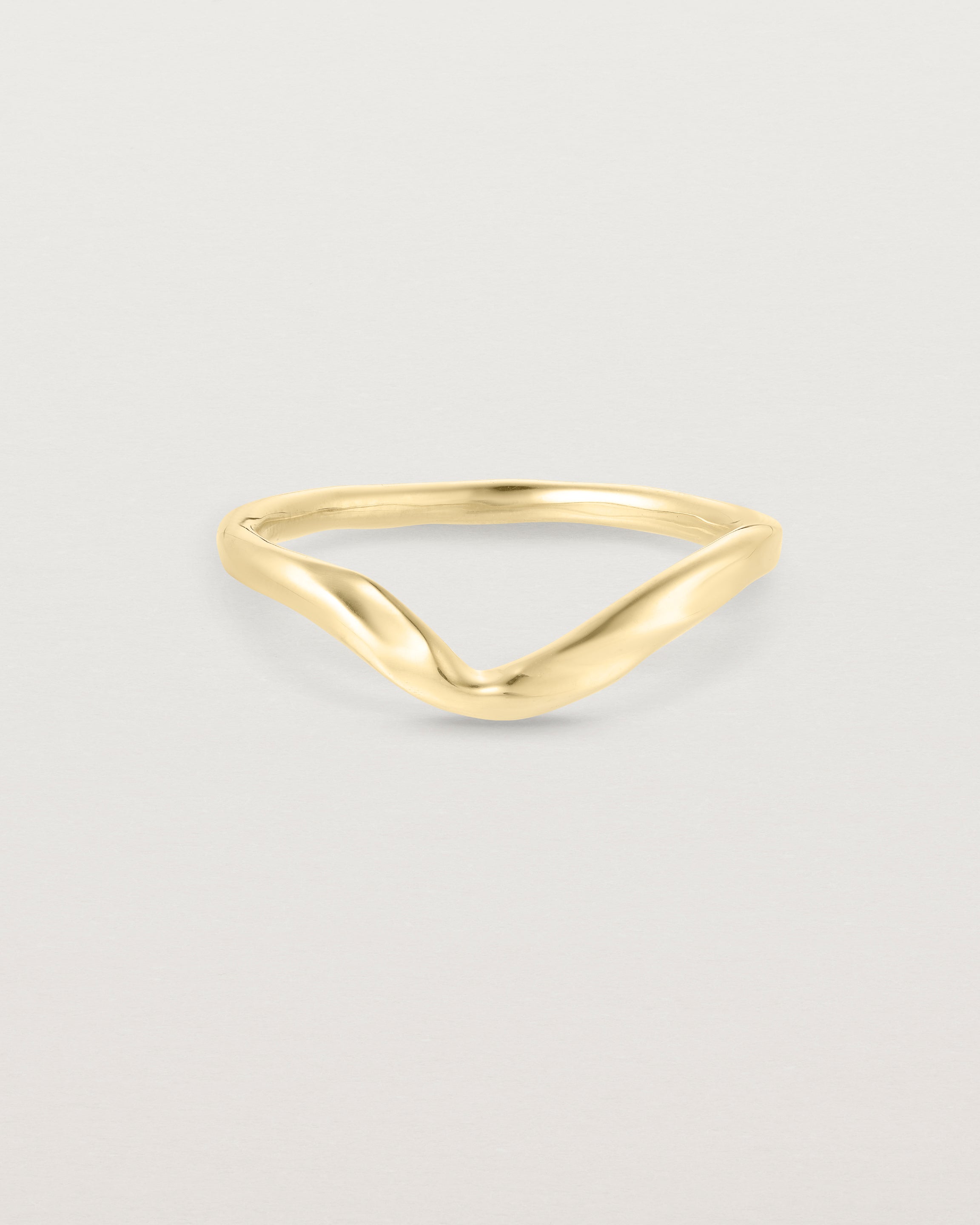 Front facing deep etched image of a yellow gold wedding band