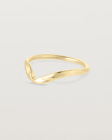 Side facing deep etched image of a yellow gold wedding band