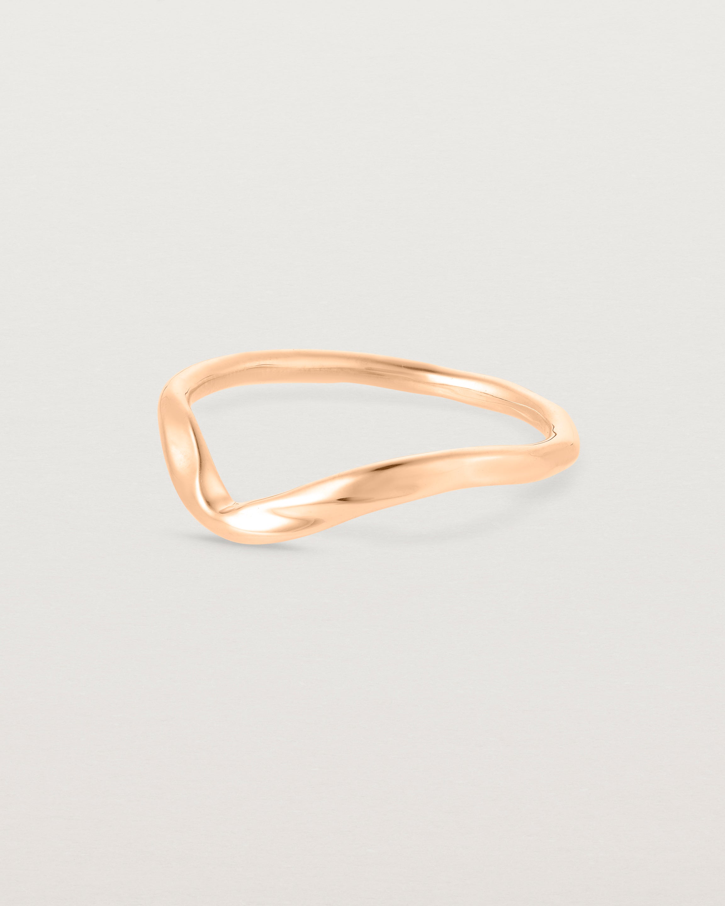 Side facing deep etched rose gold wedding band