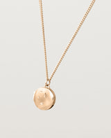 Side image of the starburst locket in rose gold.