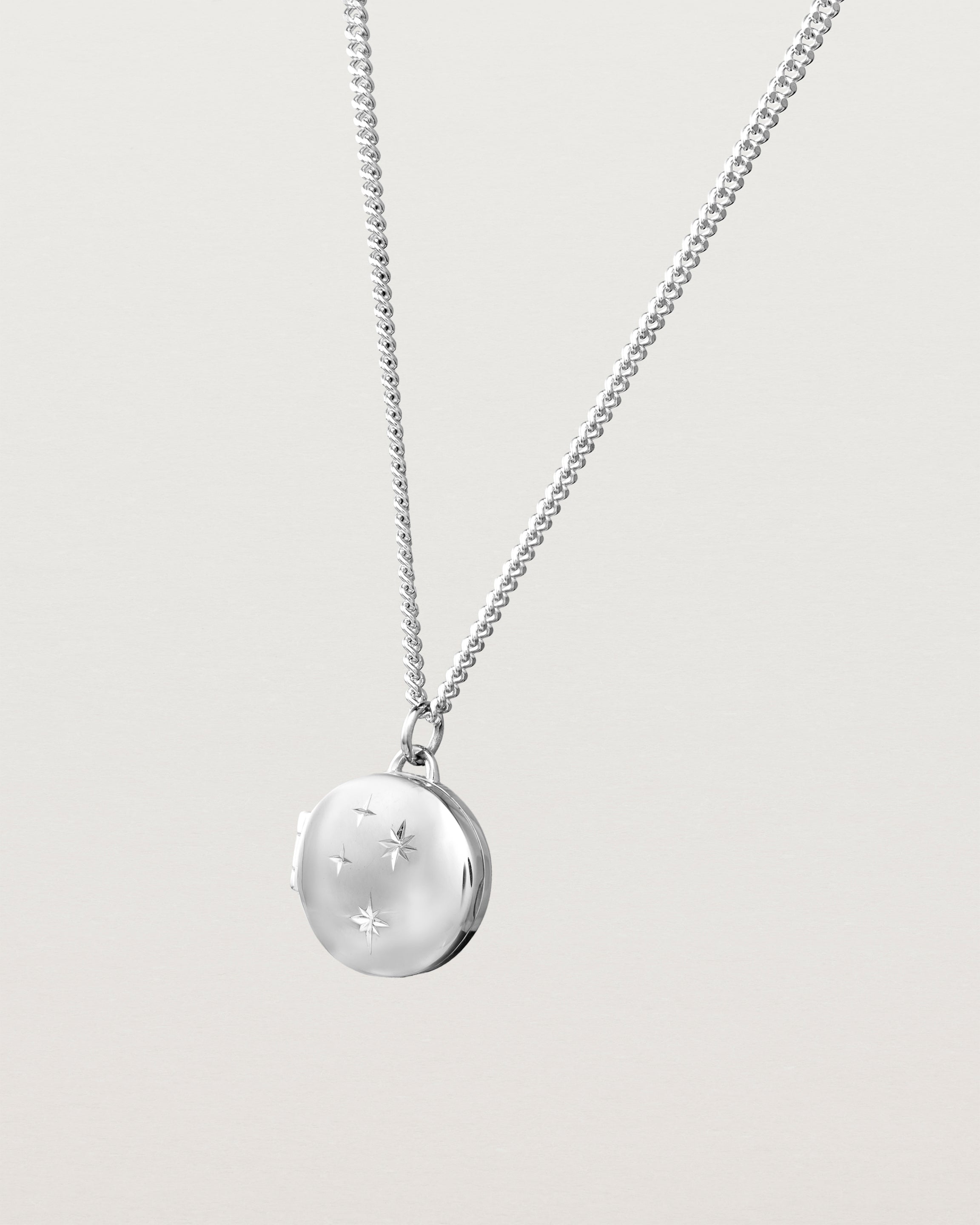 Side image of the starburst locket in sterling silver