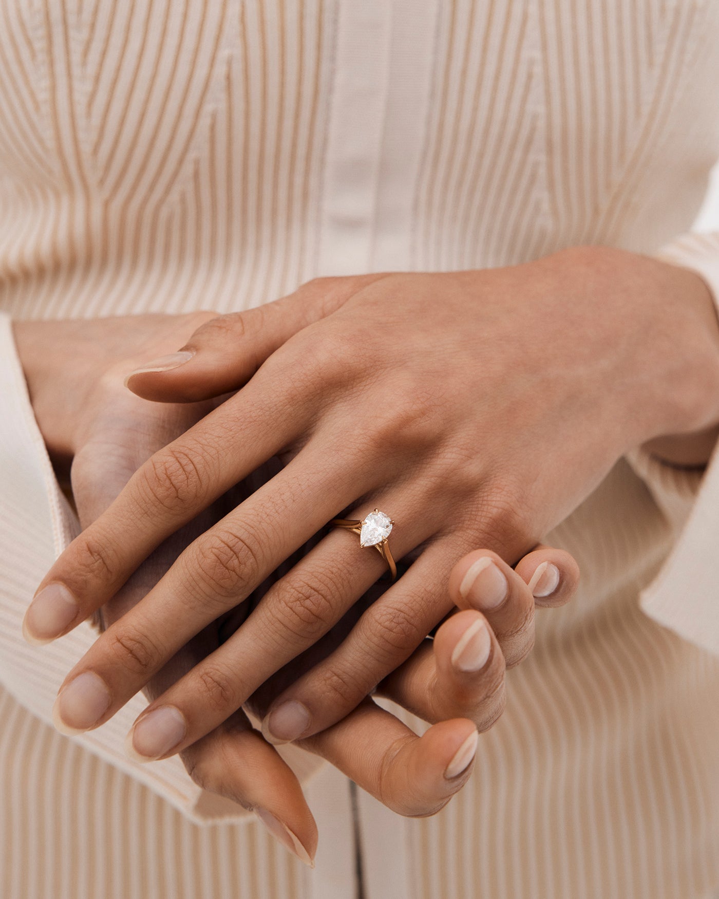 A woman wearing the Stella Solitaire ring in Diamond