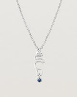 Front on deep etched image of a white gold necklace with birthstone charms.