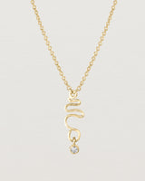 Front on deep etched image of a yellow gold necklace with birthstone charms.