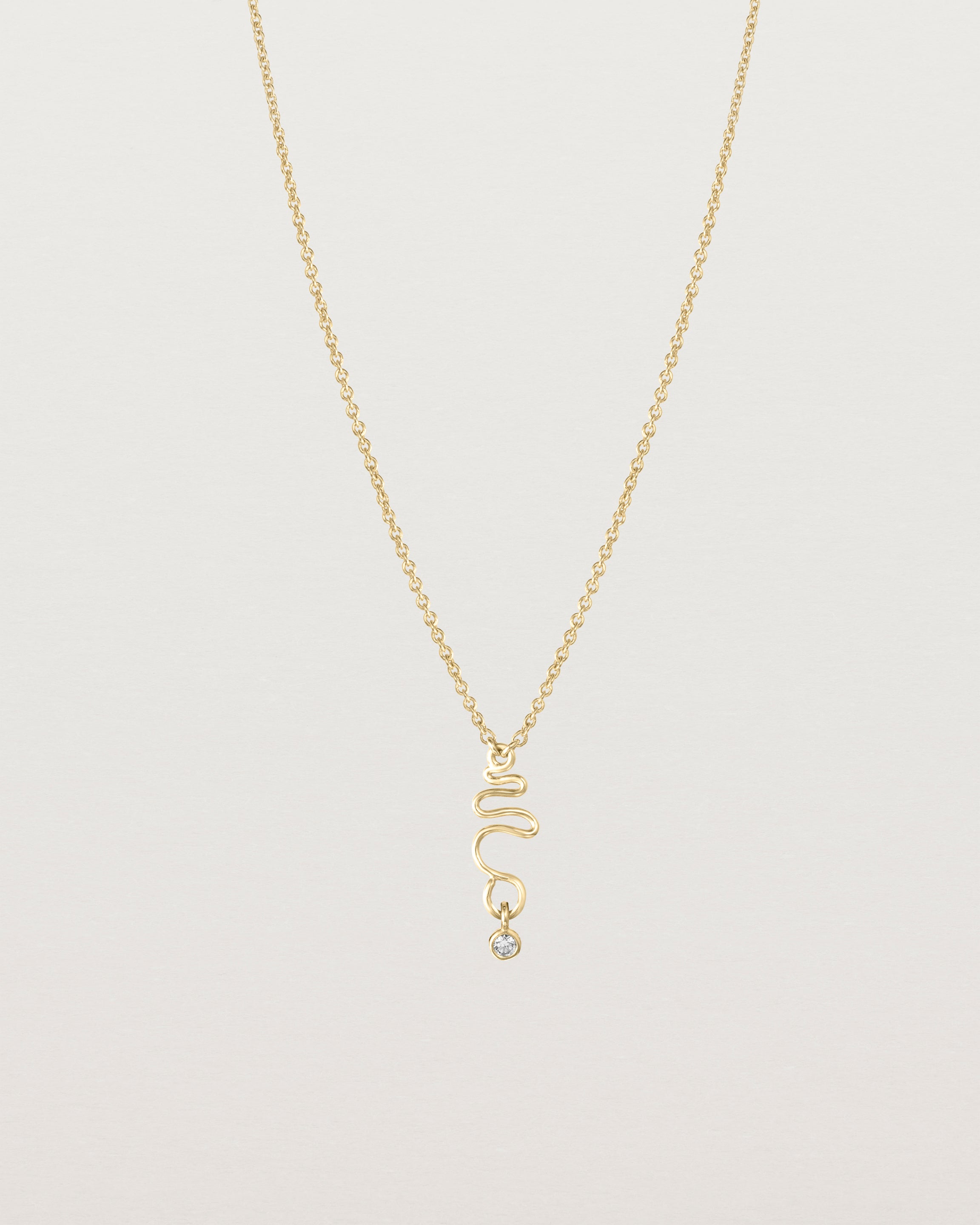 Front on deep etched image of a yellow gold necklace with birthstone charms.