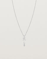 Front on deep etched image of a white gold necklace with birthstone charms.