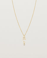 Front on deep etched image of a yellow gold necklace with birthstone charms.