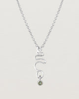 Front on deep etched image of a white gold necklace with birthstone charms.