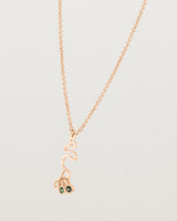 Side facing deep etched image of a rose gold necklace with birthstone charms.
