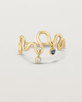 Front on deep etched image of a yellow gold ring with birthstone charms.