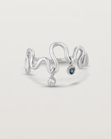 Front on deep etched image of a white gold ring with birthstone charms.