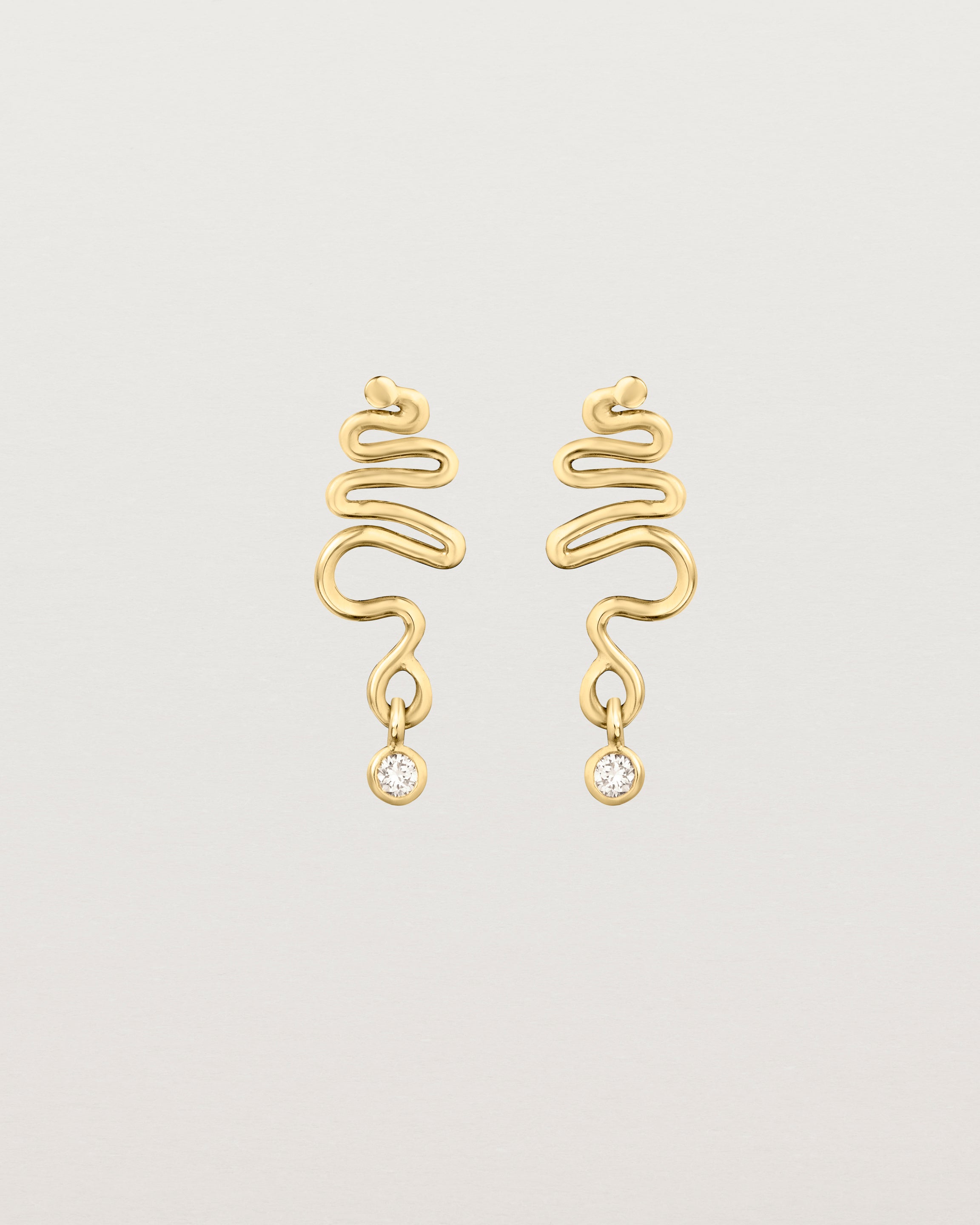 Front on deep etched image of a yellow gold earrings with birthstone.