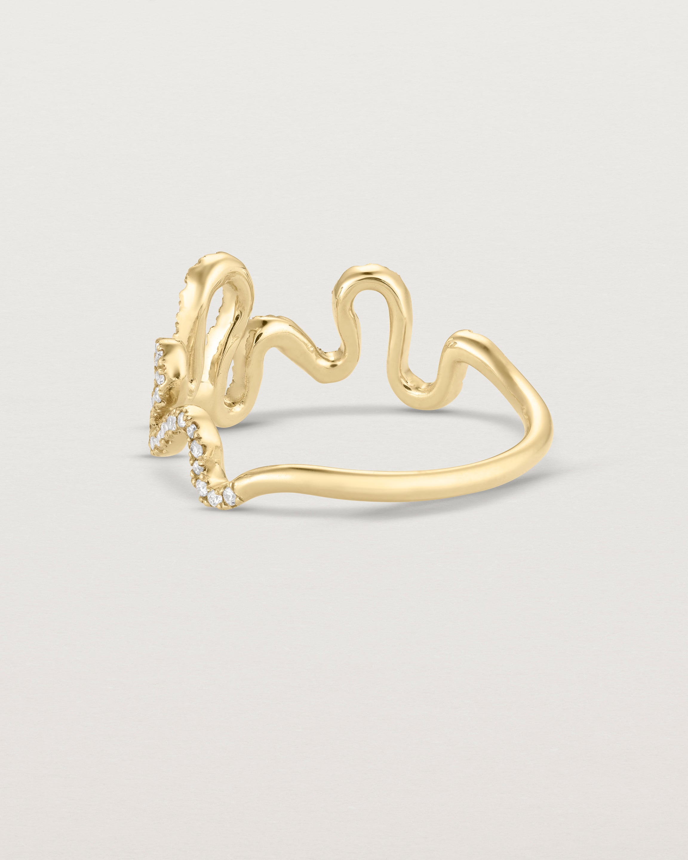 Back facing deep etched image of a yellow gold ring with a whirl of 68 diamonds.