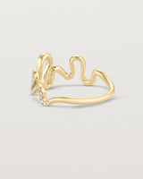 Back facing deep etched image of a yellow gold ring with a whirl of 68 diamonds.