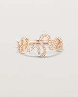 Front on deep etched image of a rose gold ring with a whirl of 68 diamonds.