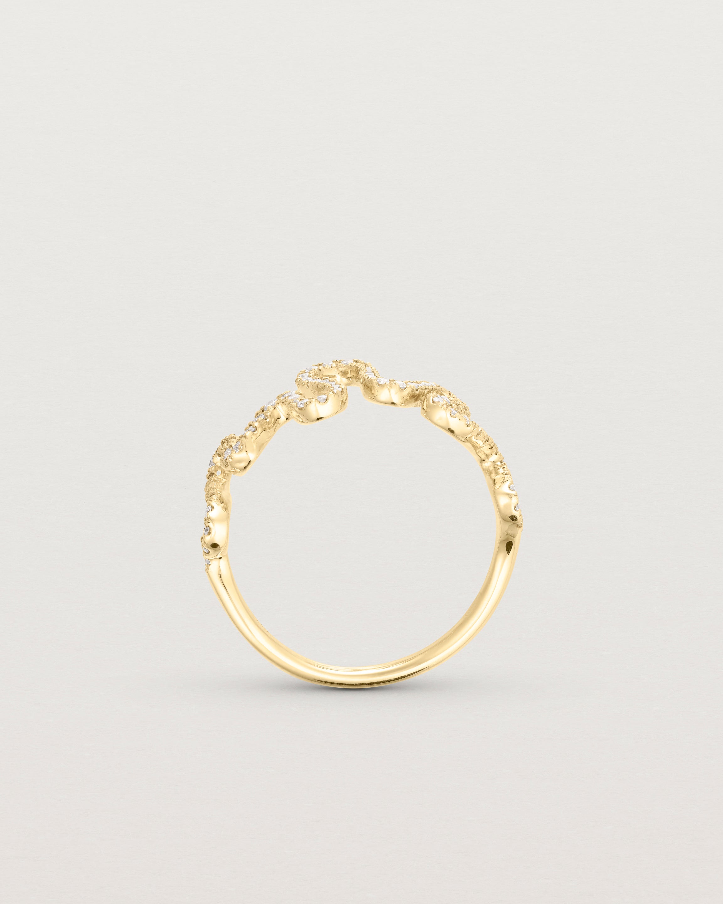 Standing deep etched image of a yellow gold ring with a whirl of 68 diamonds.