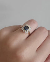 Video on hand of of a halo engagement ring with Australian sapphires and diamonds.