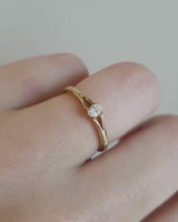 Front on deep etched video of a yellow gold engagement ring with an oval diamond.