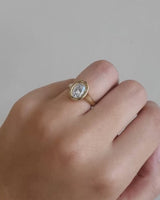 Video on hand of a yellow gold oval diamond engagement ring